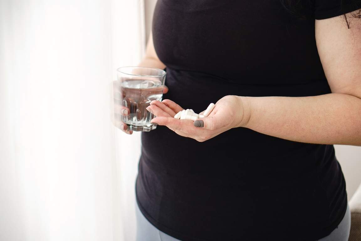 Overweight woman take pills