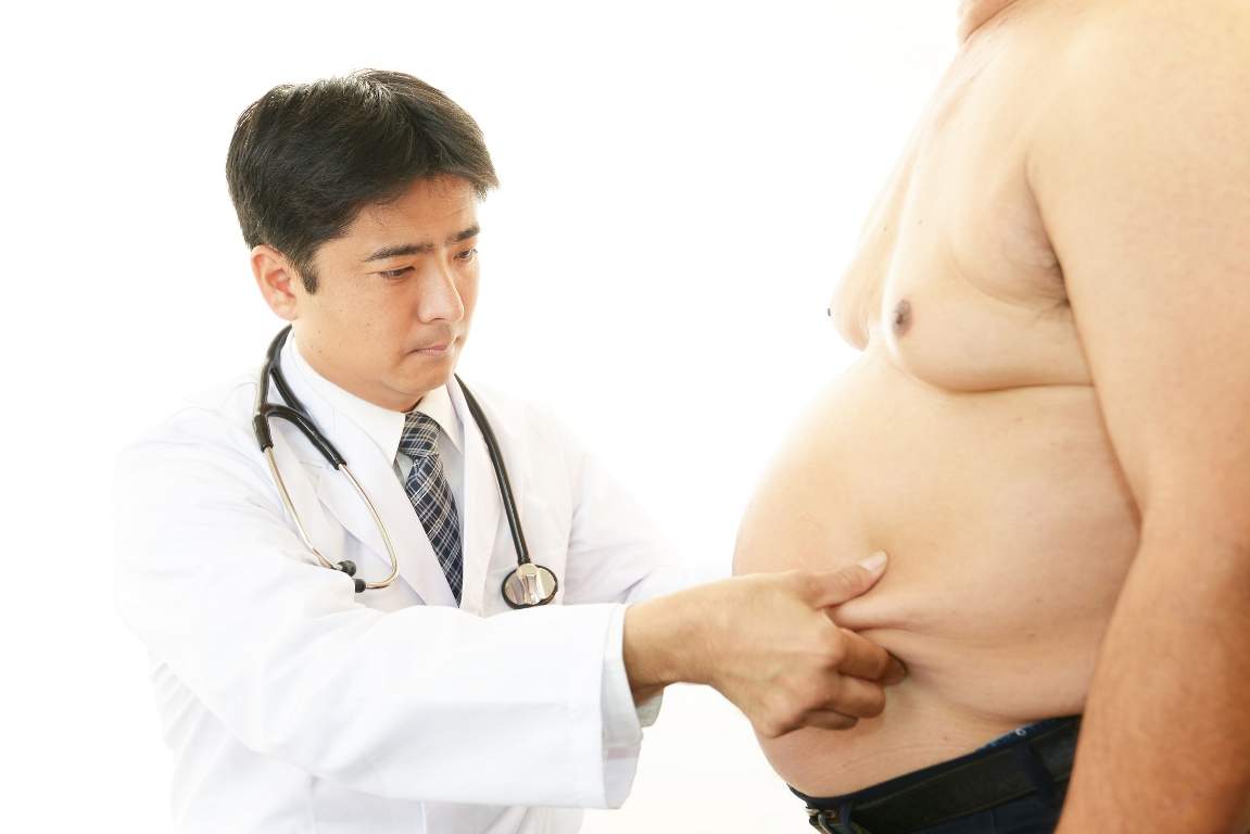 Serious doctor examining a patient obesity