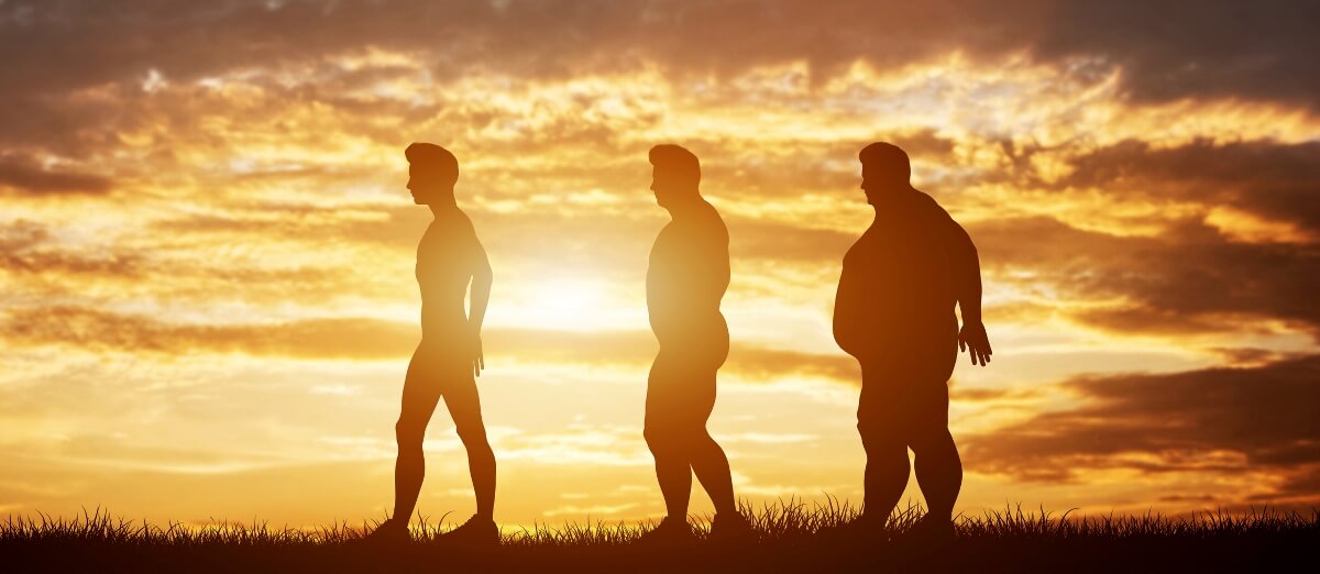 Three men silhouettes with different body types on a sunset sky