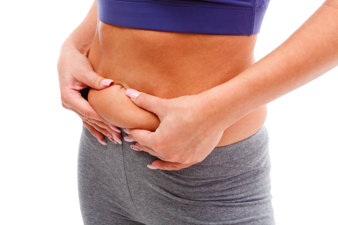 Young woman measuring her weight gain