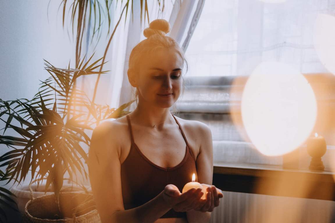 Young woman sitting on floor do yoga exercise and meditation at home 